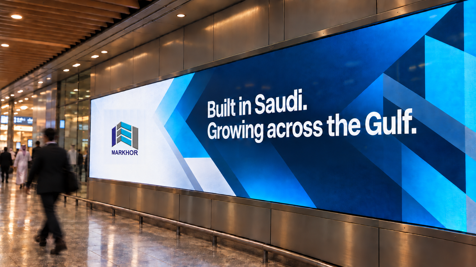 Markhor campaign mockup on a concourse billboard: Built in Saudi. Growing across the Gulf.